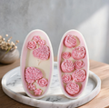 Heart Shape and Peony Bloom rose candle sets standing upright on marble tray