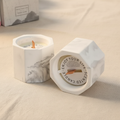 Marble geometric candle on beige linen warm natural light